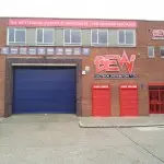 Cut-out logos and aluminium panels on a masonry unit